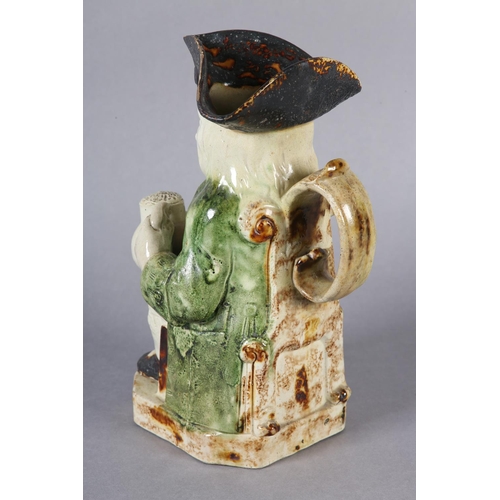 79 - A RALPH WOOD TYPE CREAMWARE TOBY JUG c1790-1800 of typical form, glazed in green and brown, 24cm hig... 