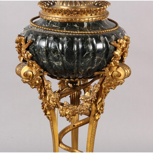 43 - A FRENCH DARK GREEN MARBLE AND GILT METAL TABLE LAMP, raised on three legs with bearded face mask pa... 