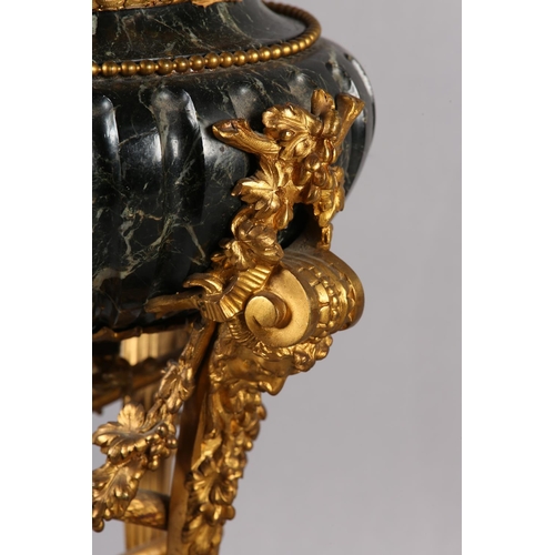 43 - A FRENCH DARK GREEN MARBLE AND GILT METAL TABLE LAMP, raised on three legs with bearded face mask pa... 