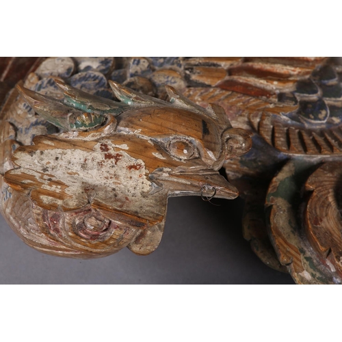 115 - AN 18TH/EARLY 19TH CENTURY POLYCHROME PAINTED PINE CARVING OF A PHOENIX AMONGST CLOUDS, 58cm wide x ... 