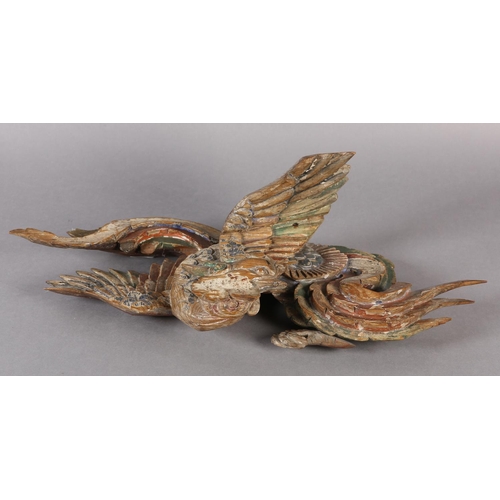 115 - AN 18TH/EARLY 19TH CENTURY POLYCHROME PAINTED PINE CARVING OF A PHOENIX AMONGST CLOUDS, 58cm wide x ... 