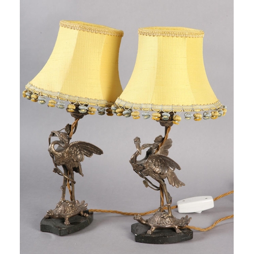 38 - A PAIR OF EPNS TABLE LAMPS IN THE FORM OF A CRANE PERCHED ON THE BACK OF A TURTLE, on black marble p... 