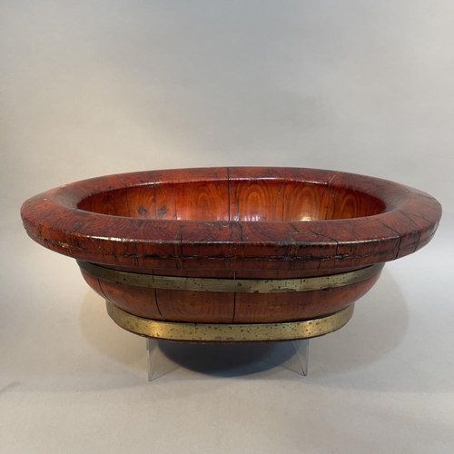 117 - A CHINESE LACQUERED WOOD AND BRASS BOUND WASH BOWL, Qing, oval, with broad rim, c1900, 51cm x 42cm x... 