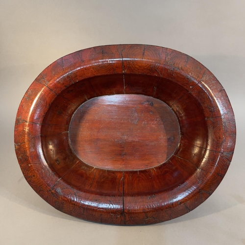 117 - A CHINESE LACQUERED WOOD AND BRASS BOUND WASH BOWL, Qing, oval, with broad rim, c1900, 51cm x 42cm x... 