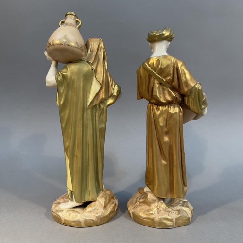 88 - A PAIR OF ROYAL WORCESTER ARAB WATER CARRIERS, blush ivory enriched in gilt, the male and female fig... 