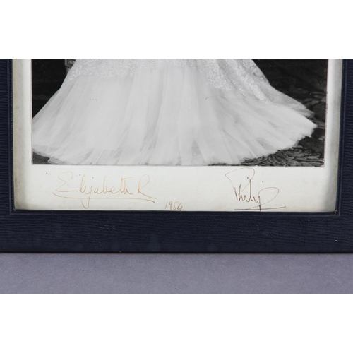 2 - QUEEN ELIZABETH II AND PHILIP, DUKE OF EDINBURGH, a signed photograph dated 1954, in dark blue leath... 