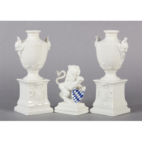 106 - A PAIR OF LATE 19TH CENTURY NYMPHENBURG WHITE PORCELAIN VASES RAISED ON INTEGRAL PLINTHS, 15.5cm tog... 