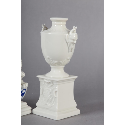 106 - A PAIR OF LATE 19TH CENTURY NYMPHENBURG WHITE PORCELAIN VASES RAISED ON INTEGRAL PLINTHS, 15.5cm tog... 