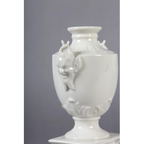 106 - A PAIR OF LATE 19TH CENTURY NYMPHENBURG WHITE PORCELAIN VASES RAISED ON INTEGRAL PLINTHS, 15.5cm tog... 