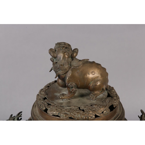 120 - A CHINESE BRONZE KORO, Qing, the domed and pierced cover surmounted with a dog of fo, the body with ... 