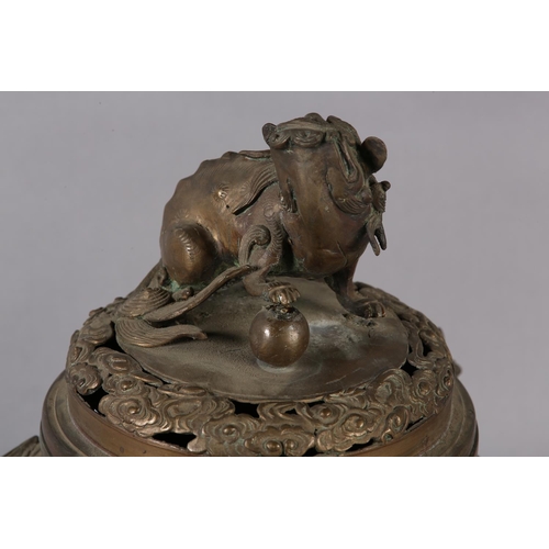 120 - A CHINESE BRONZE KORO, Qing, the domed and pierced cover surmounted with a dog of fo, the body with ... 