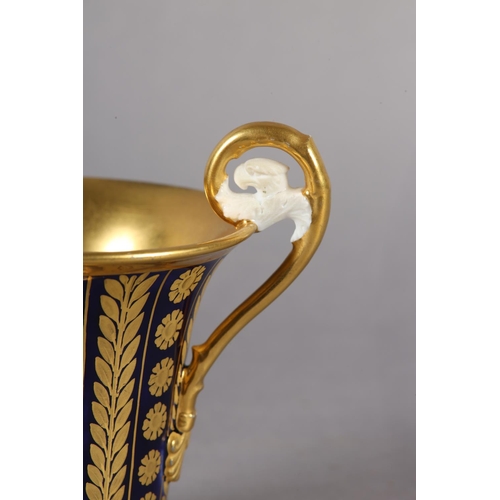 102 - A 19TH CENTURY CONTINENTAL GILT CHOCOLATE CUP, in the manner of Schoelcher the moulded handle termin... 