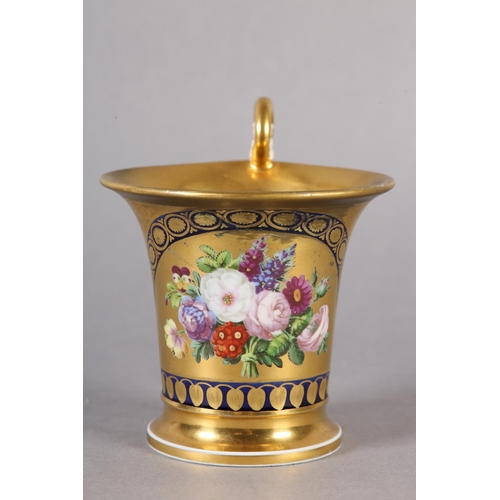 102 - A 19TH CENTURY CONTINENTAL GILT CHOCOLATE CUP, in the manner of Schoelcher the moulded handle termin... 