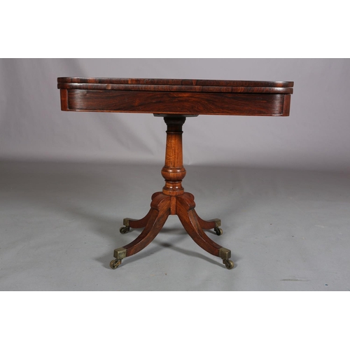 397 - A LATE REGENCY ROSEWOOD CARD TABLE, the rectangular fold-over top lined in baize, on a vase turned c... 