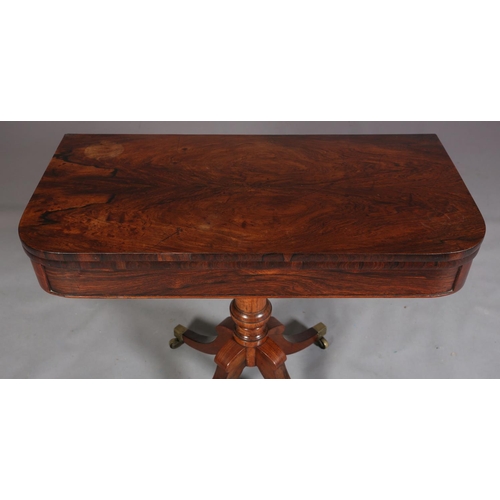 397 - A LATE REGENCY ROSEWOOD CARD TABLE, the rectangular fold-over top lined in baize, on a vase turned c... 