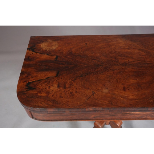 397 - A LATE REGENCY ROSEWOOD CARD TABLE, the rectangular fold-over top lined in baize, on a vase turned c... 