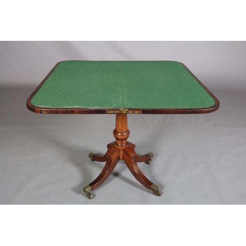 397 - A LATE REGENCY ROSEWOOD CARD TABLE, the rectangular fold-over top lined in baize, on a vase turned c... 