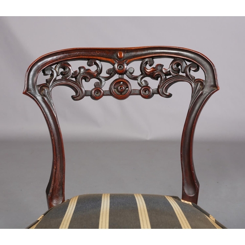 394 - A VICTORIAN MAHOGANY NURSING CHAIR, with pierced foliate carved open back, upholstered seat, on cabr... 