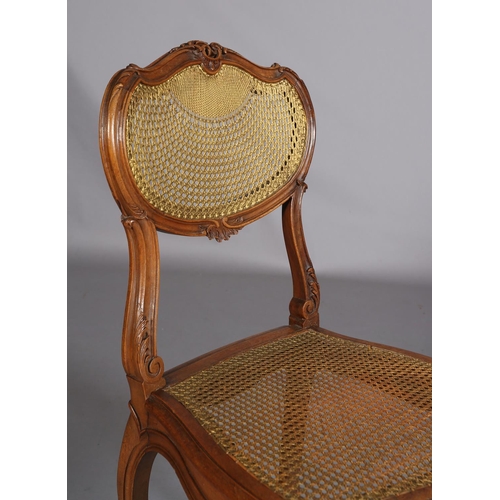 395 - A VICTORIAN WALNUT AND GILDED BERGERE CANED SALON CHAIR, having an oval back with moulded encircling... 