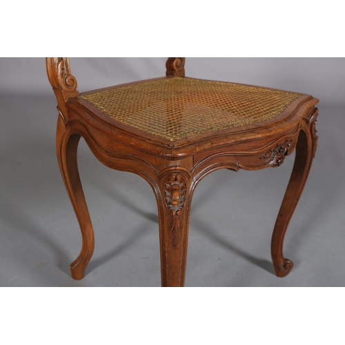 395 - A VICTORIAN WALNUT AND GILDED BERGERE CANED SALON CHAIR, having an oval back with moulded encircling... 