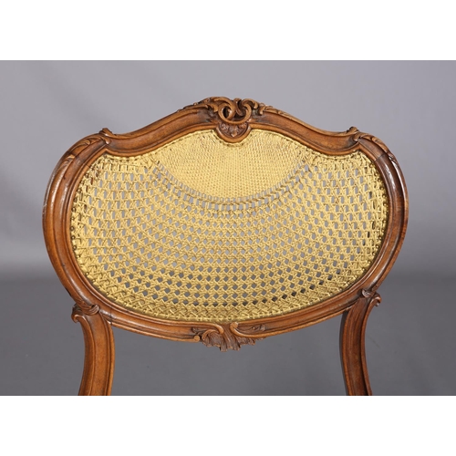 395 - A VICTORIAN WALNUT AND GILDED BERGERE CANED SALON CHAIR, having an oval back with moulded encircling... 