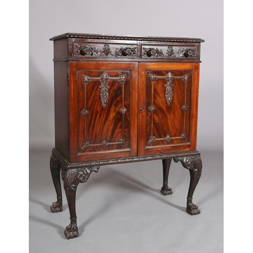 383 - A MAHOGANY CABINET, c1900, having a gadroon rim above two drawers with applied foliate scroll work a... 