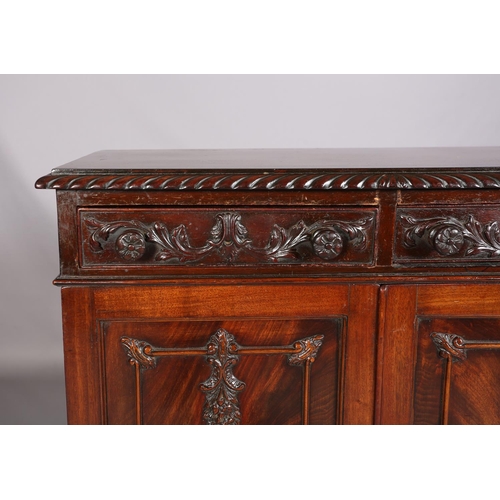 383 - A MAHOGANY CABINET, c1900, having a gadroon rim above two drawers with applied foliate scroll work a... 