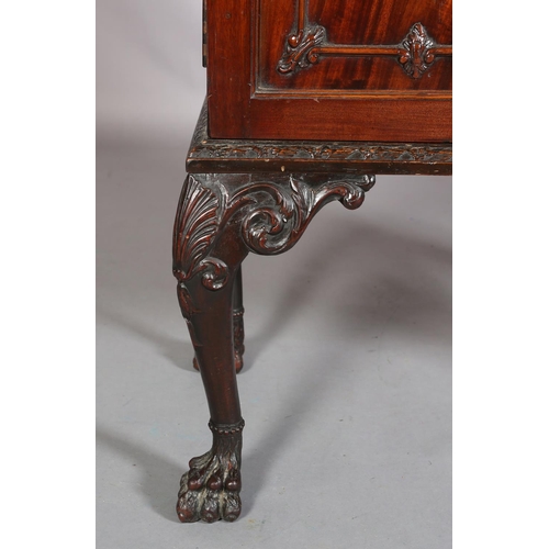 383 - A MAHOGANY CABINET, c1900, having a gadroon rim above two drawers with applied foliate scroll work a... 