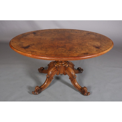 414 - A VICTORIAN FIGURED WALNUT LOOE TABLE, oval, having a quarter veneer tilt top, on a turned and beade... 