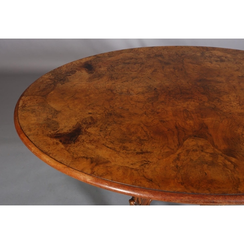 414 - A VICTORIAN FIGURED WALNUT LOOE TABLE, oval, having a quarter veneer tilt top, on a turned and beade... 