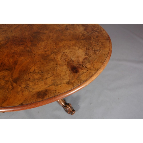 414 - A VICTORIAN FIGURED WALNUT LOOE TABLE, oval, having a quarter veneer tilt top, on a turned and beade... 