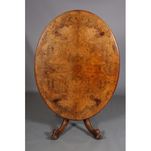 414 - A VICTORIAN FIGURED WALNUT LOOE TABLE, oval, having a quarter veneer tilt top, on a turned and beade... 