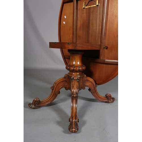 414 - A VICTORIAN FIGURED WALNUT LOOE TABLE, oval, having a quarter veneer tilt top, on a turned and beade... 