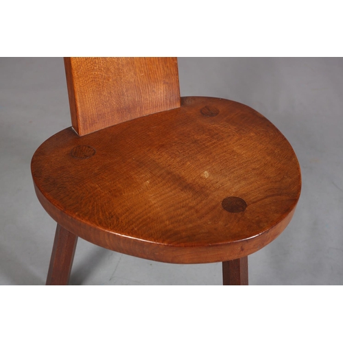 350 - THOMPSON OF KILBURN 'MOUSEMAN', an oak spinning chair the tapered back with finger grip, on three ch... 