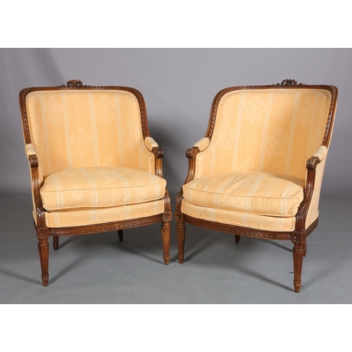 416 - A PAIR OF LOUIS XVI-STYLE BERGERES, having a riband carved encircling frame with ribbon cresting, up... 