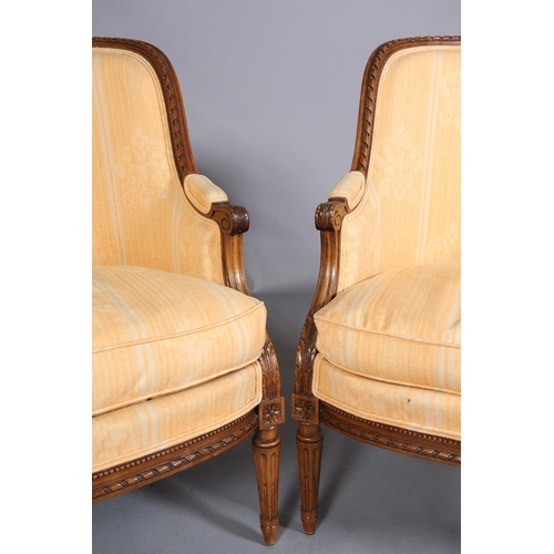 416 - A PAIR OF LOUIS XVI-STYLE BERGERES, having a riband carved encircling frame with ribbon cresting, up... 