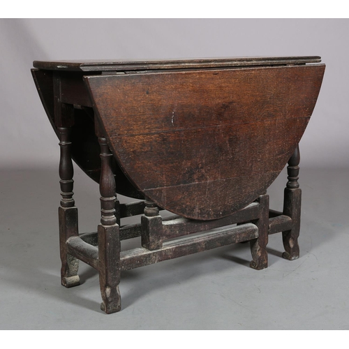 360 - AN 18TH CENTURY OAK GATELEG SUPPER TABLE, having twin oval drop leaves on baluster turned and square... 