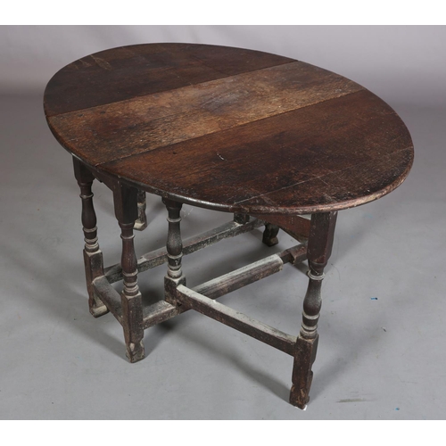 360 - AN 18TH CENTURY OAK GATELEG SUPPER TABLE, having twin oval drop leaves on baluster turned and square... 