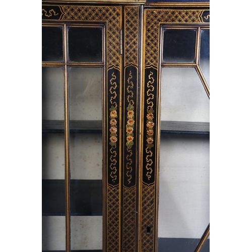 388 - AN EBONISED AND GILT CHINOISERIE BREAKFRONT BOOKCASE CABINET, the top gilded with island vignette ab... 