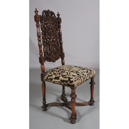 412 - A CAROLEAN WALNUT SIDE CHAIR, having a pierced panel back and cresting carved with face mask and lea... 