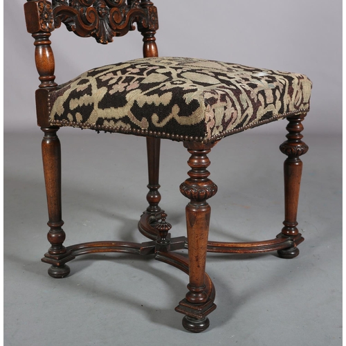 412 - A CAROLEAN WALNUT SIDE CHAIR, having a pierced panel back and cresting carved with face mask and lea... 