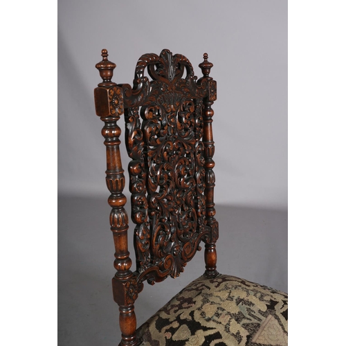 412 - A CAROLEAN WALNUT SIDE CHAIR, having a pierced panel back and cresting carved with face mask and lea... 