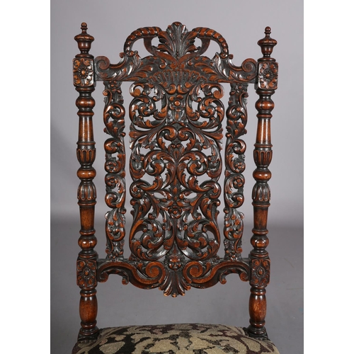 412 - A CAROLEAN WALNUT SIDE CHAIR, having a pierced panel back and cresting carved with face mask and lea... 