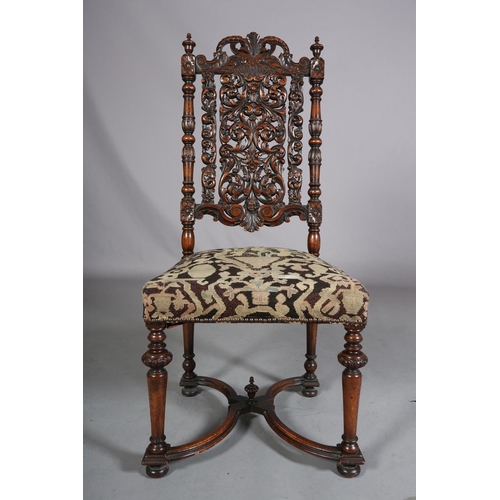 412 - A CAROLEAN WALNUT SIDE CHAIR, having a pierced panel back and cresting carved with face mask and lea... 