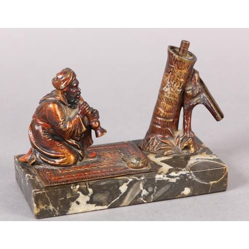 60 - AN AUSTRIAN COLD PAINTED BRONZE CIGAR LIGHTER moulded as a snake charmer, the palm tree stamp incorp... 