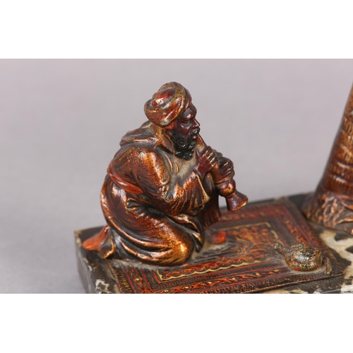 60 - AN AUSTRIAN COLD PAINTED BRONZE CIGAR LIGHTER moulded as a snake charmer, the palm tree stamp incorp... 