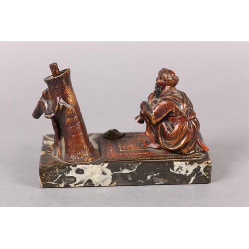 60 - AN AUSTRIAN COLD PAINTED BRONZE CIGAR LIGHTER moulded as a snake charmer, the palm tree stamp incorp... 