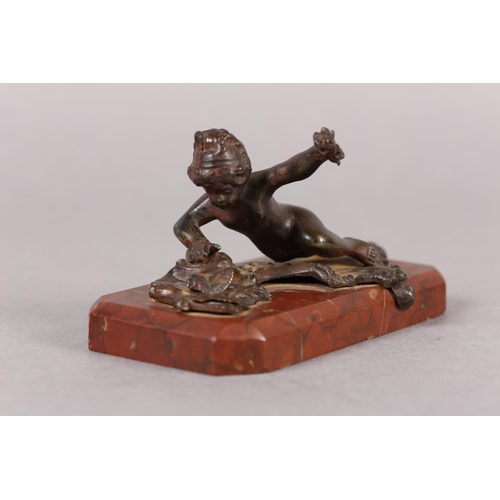 61 - A LATE 19TH CENTURY COLD PAINTED BRONZE FIGURE of an infant girl and butterfly, on red marble base, ... 