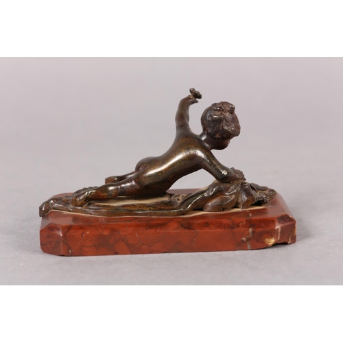 61 - A LATE 19TH CENTURY COLD PAINTED BRONZE FIGURE of an infant girl and butterfly, on red marble base, ... 