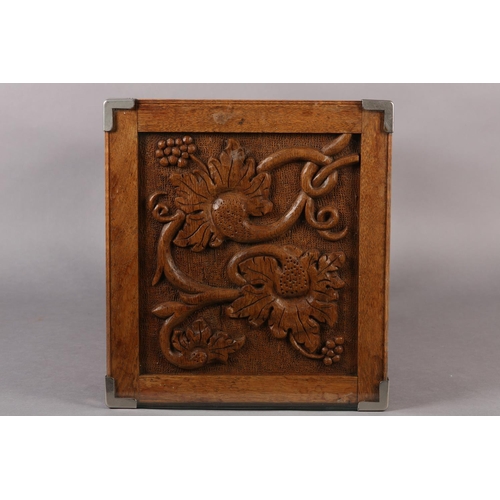 390 - AN ARTS & CRAFTS OAK OCCASIONAL TABLE of square outline, the surface carved in relief with plant for... 